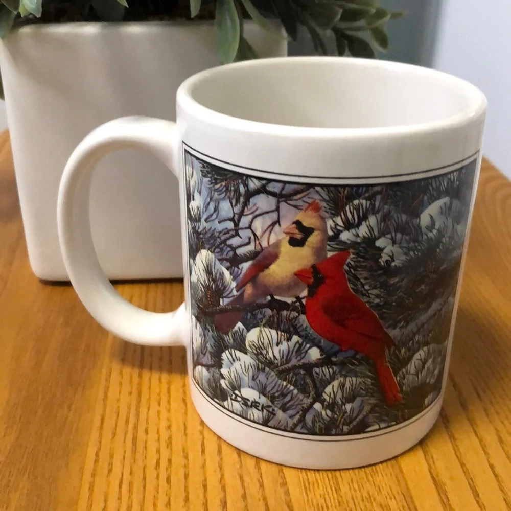Coffe cup with cardinals in winter scene